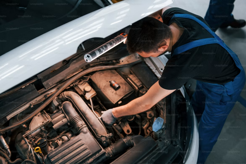 What Does Car Service Include: Mechanic inspecting engine components.