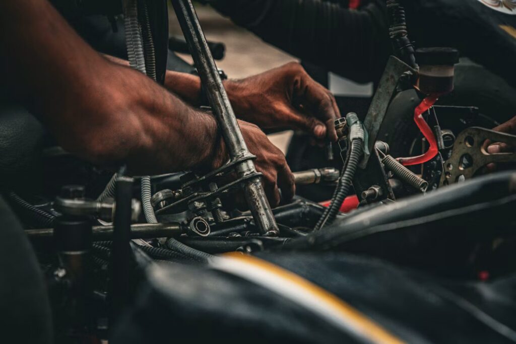 Car Maintenance Plans: a mechanic fixing a car with a tool.