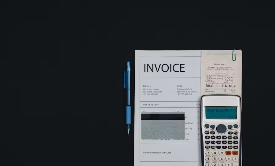 Transmission fluid replacement costs: an invoice sheet under a calculator.
