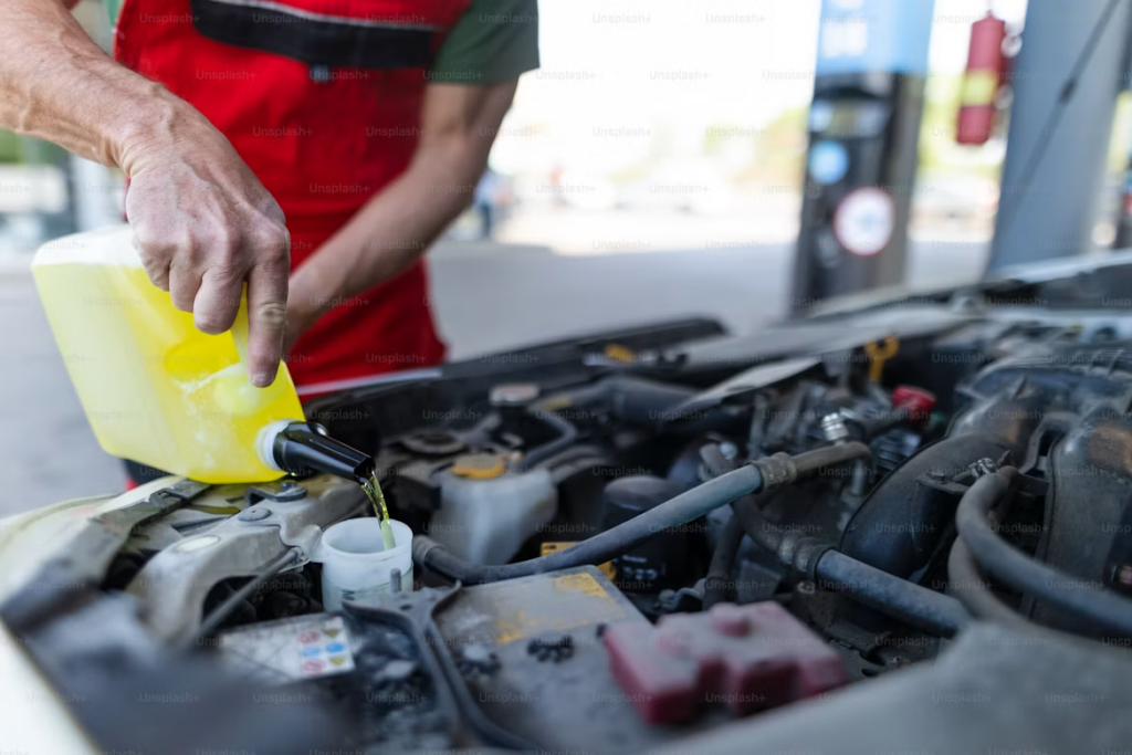 Transmission fluid replacement costs: filling oil into the car's tank.